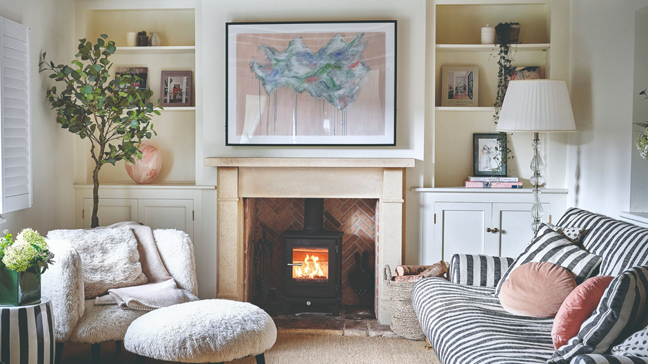 Budget-friendly living room makeover featuring a fireplace with built-in shelves and soft neutral décor