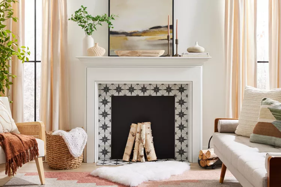 Minimalist fireplace décor with framed artwork, candles, and neutral seasonal accents