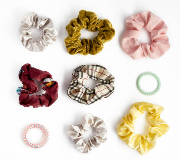 Collection of trendy elastic band scrunchies on white background.