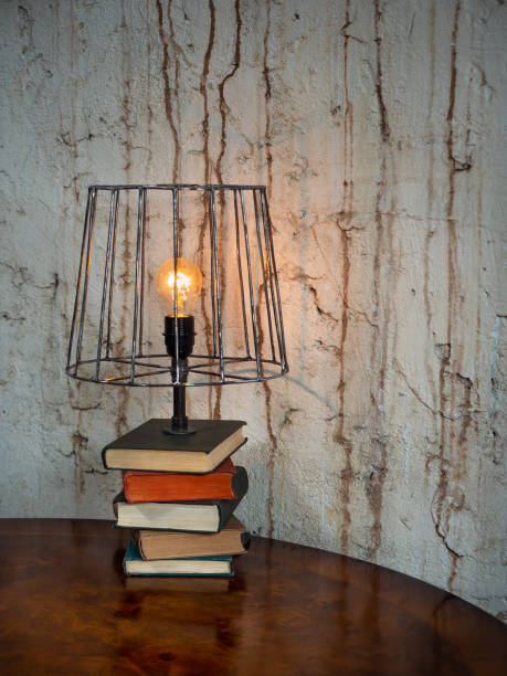 Repurposed antique, old fashioned, damaged lamp with bright shining blub.