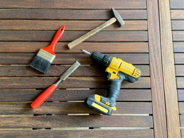 Above shot of tools on a wooden table background.