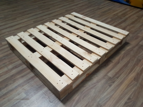 Basic wooden pallet placed on a hardwood floor, ideal for DIY pallet projects.