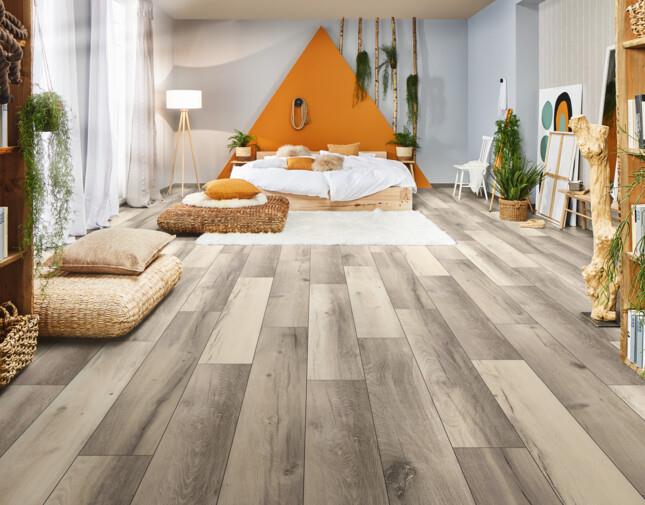 Bohemian bedroom with wide plank wood flooring and cozy seating area