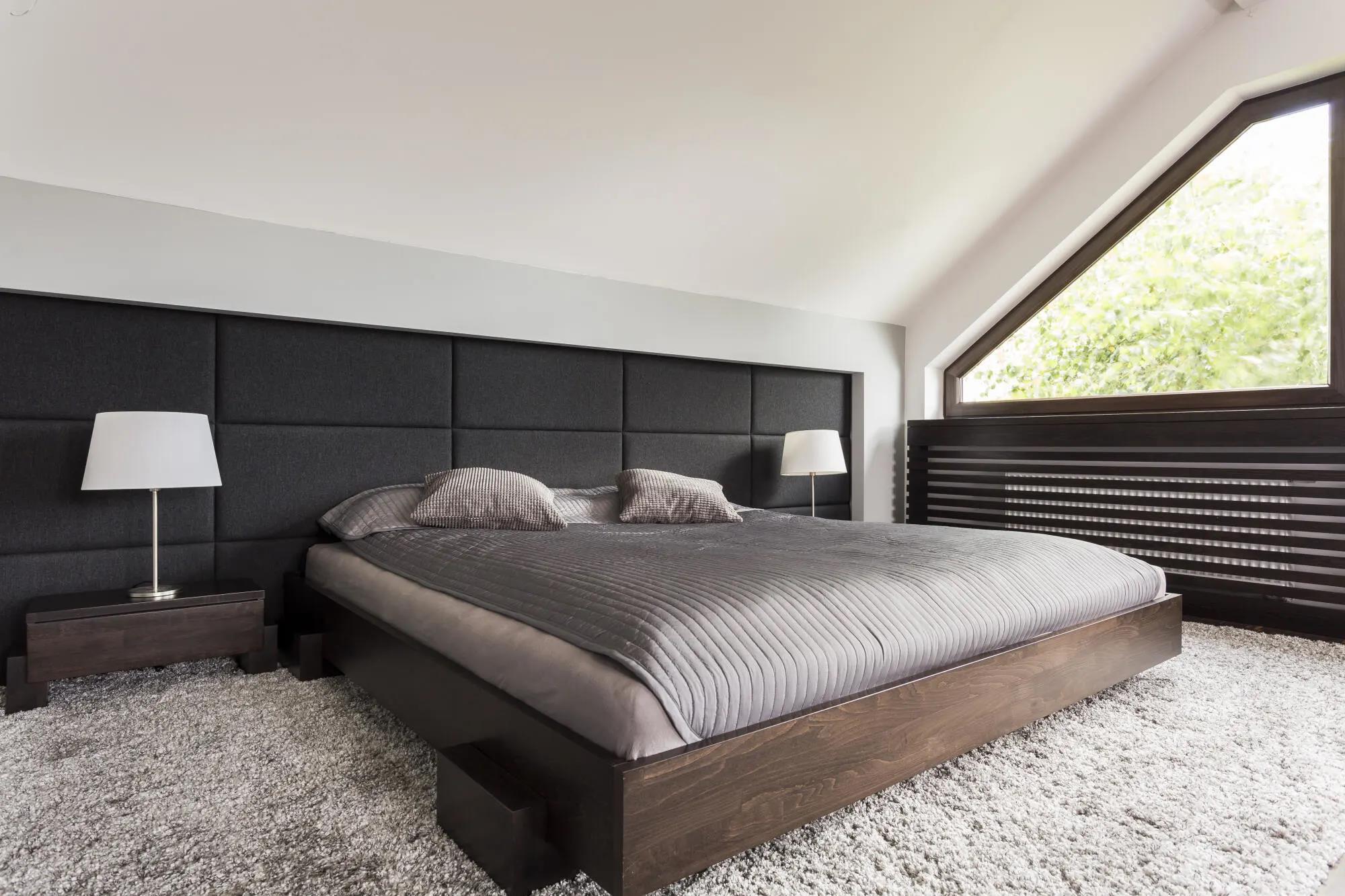 Modern bedroom with plush gray carpet flooring and minimalist decor