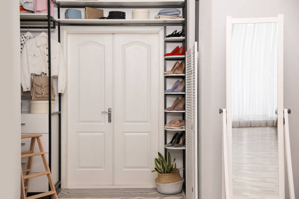 Closet space with narrow shoe shelves and full-length mirror