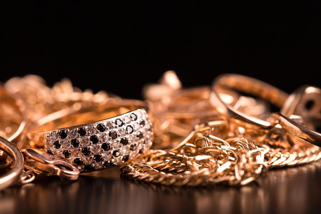 Gold ring with black stones on dark background
