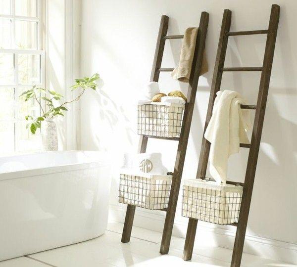 Ladder-style storage with baskets and towels beside a tub