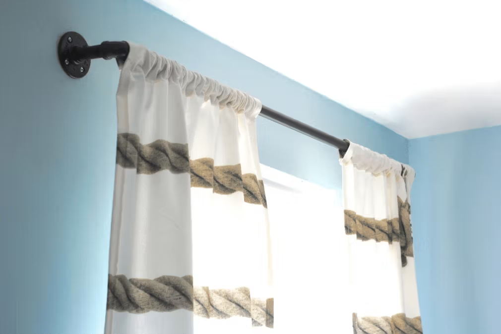 wall mounted curtain rod with sheer curtains in modern blue room window setup
