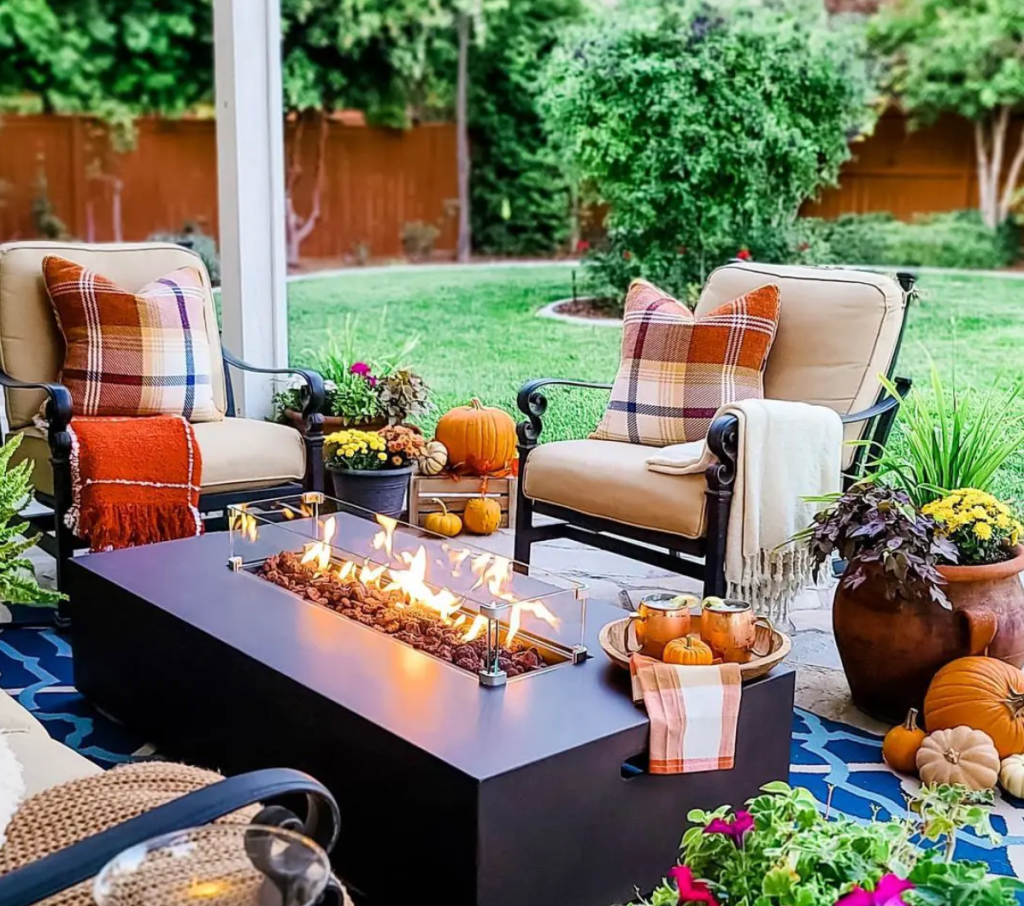 cozy outdoor patio with fire pit seating and fall decorations for backyard comfort