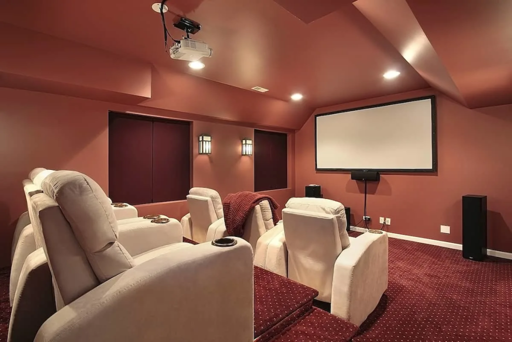 luxury media room with recliner seating projector screen acoustic walls and surround sound system