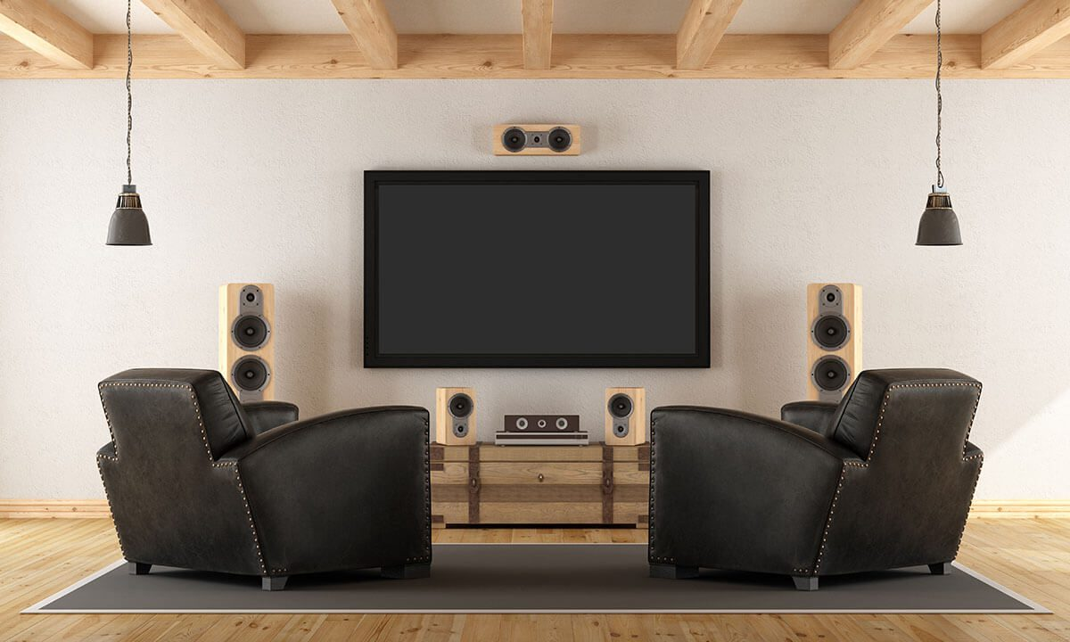 rustic modern home theater room with large screen speakers and black leather recliner chairs