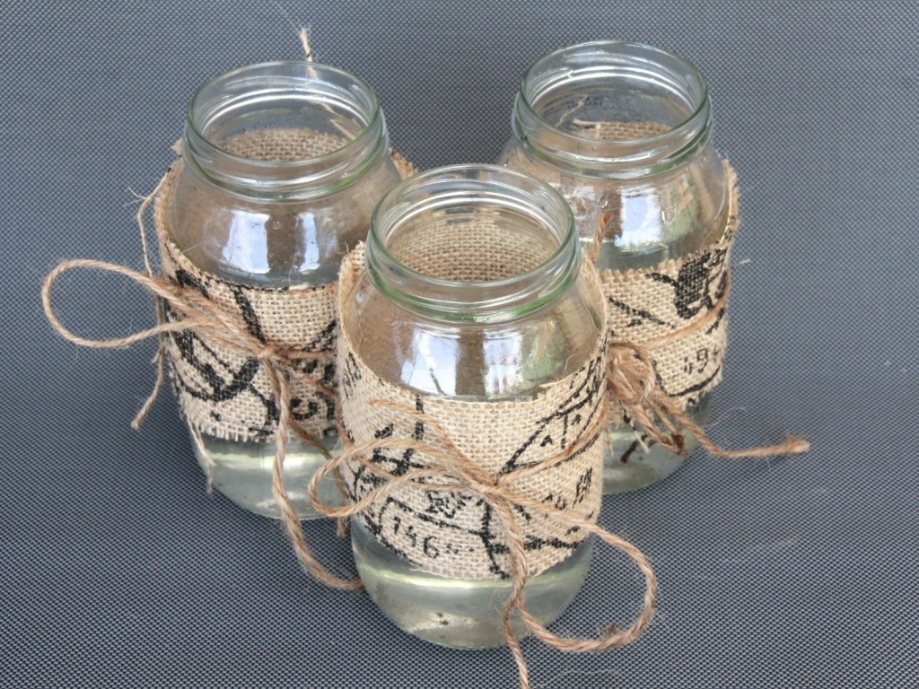 Three decorated glass jars with twine
