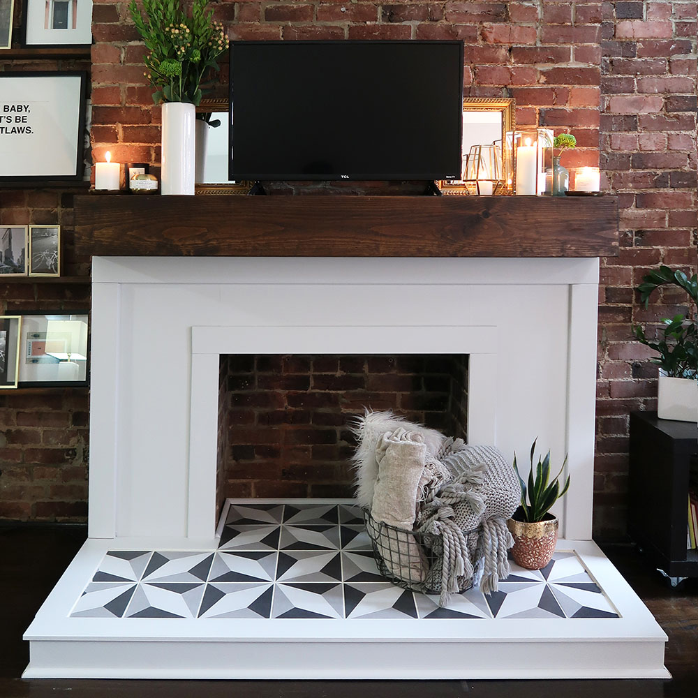 modern fireplace makeover with geometric tile hearth and rustic wood mantel in cozy living room