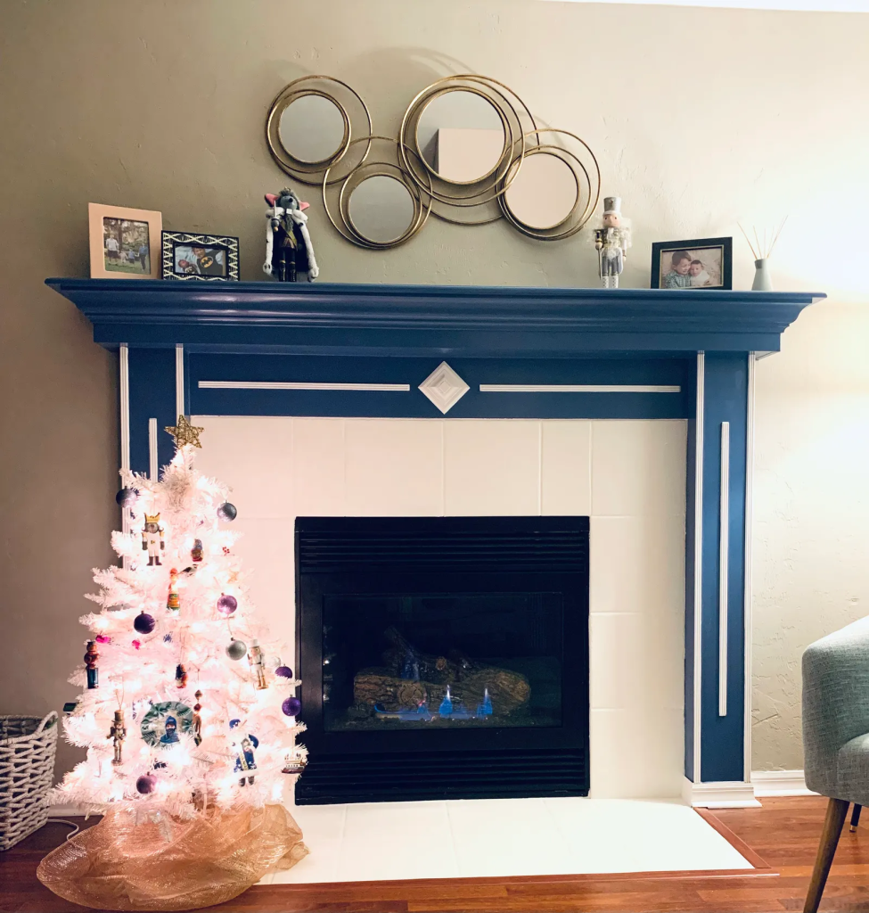 navy blue fireplace mantel makeover with modern wall decor and white Christmas tree