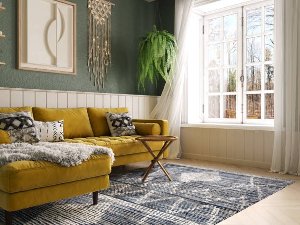 Bright living room with mustard sofa and blue patterned area rug near window