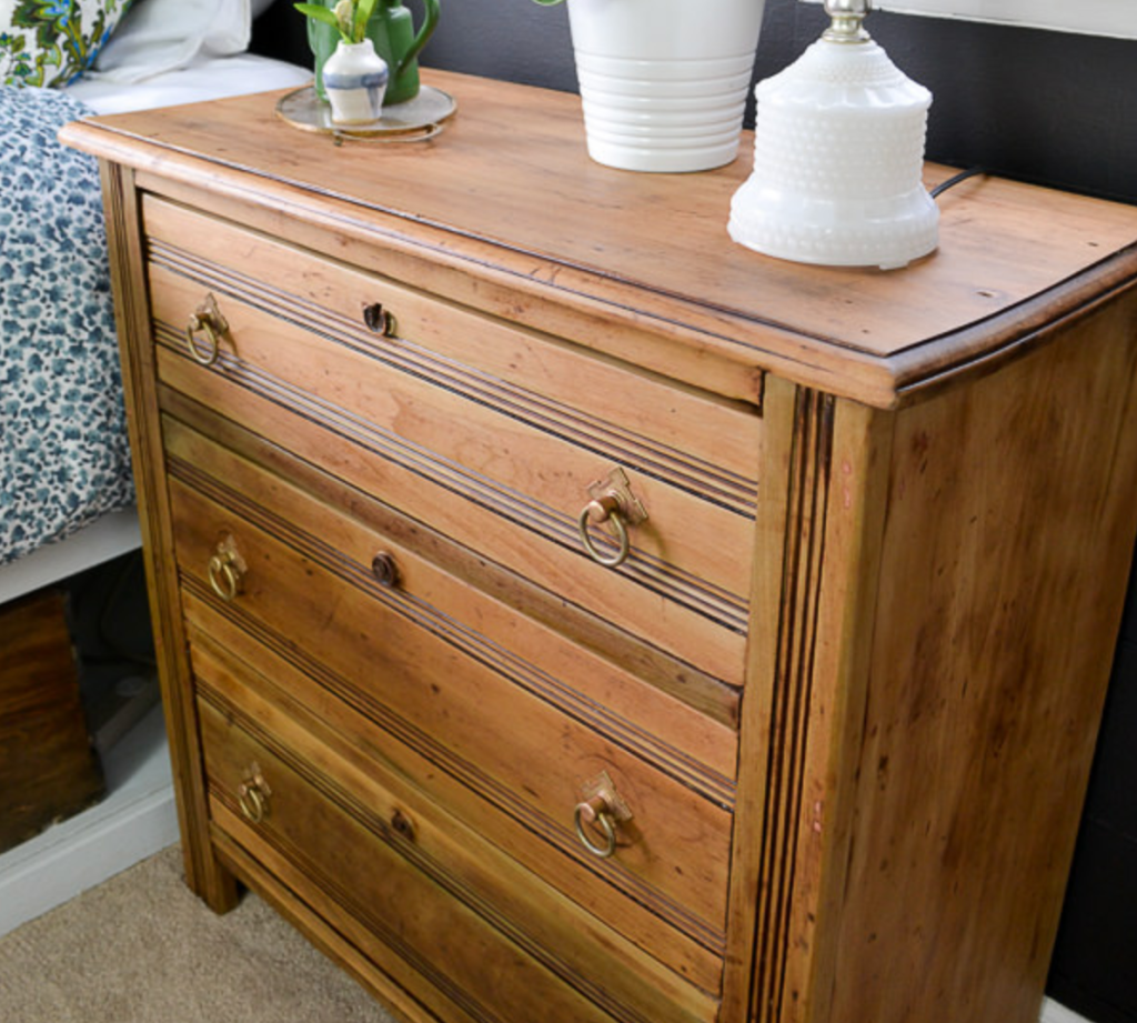 vintage wooden dresser with natural wood finish and brass drawer pulls