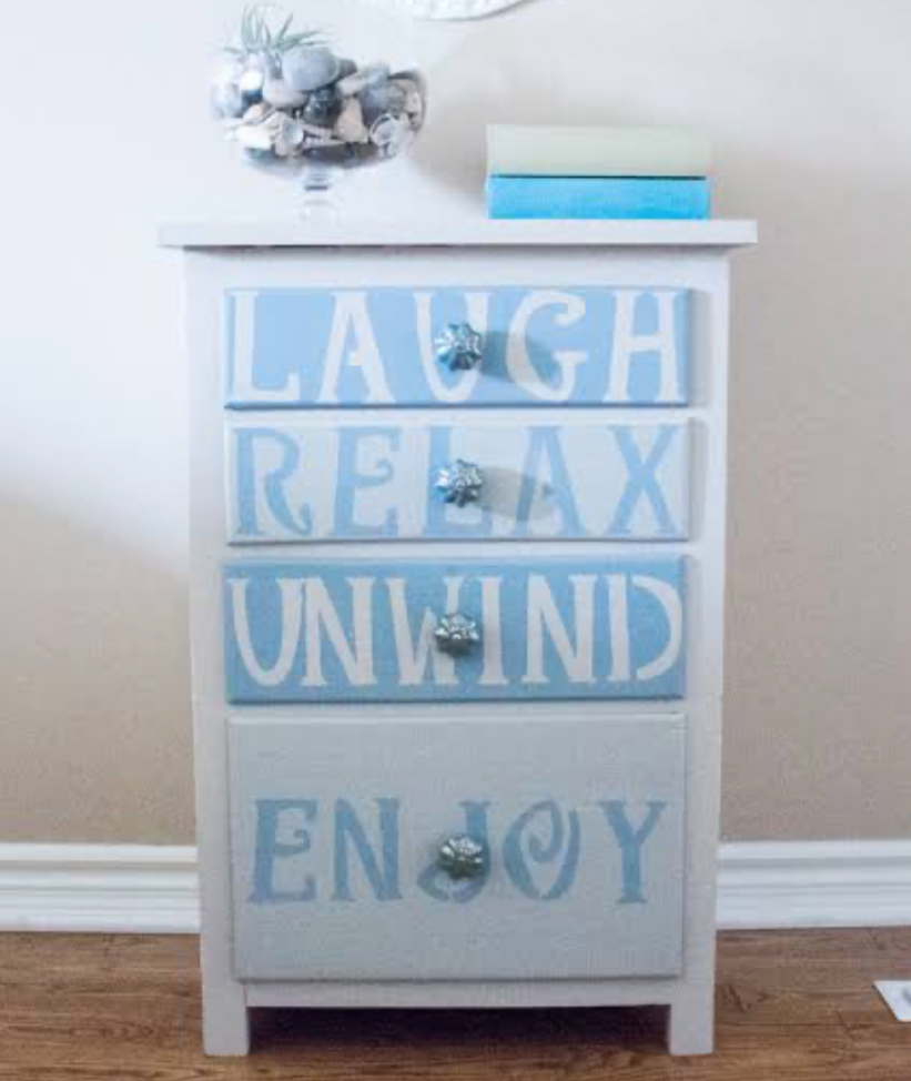 beach-themed painted nightstand with inspirational drawer lettering and coastal decor accents
