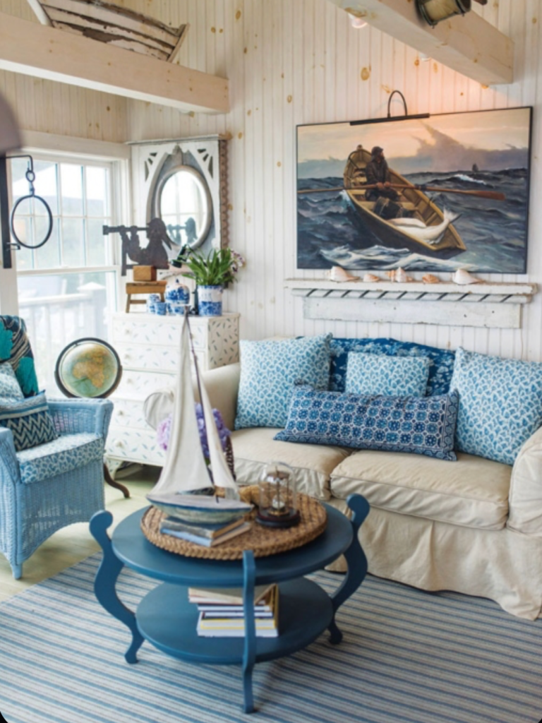 nautical coastal living room with sailboat decor, blue furniture and seaside-inspired accents