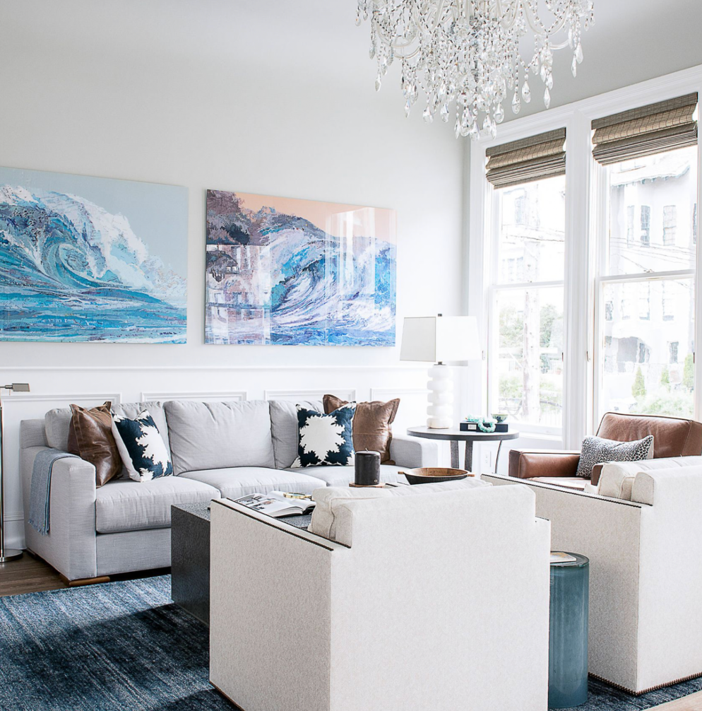 modern coastal living room with ocean artwork, neutral furniture and blue accent decor
