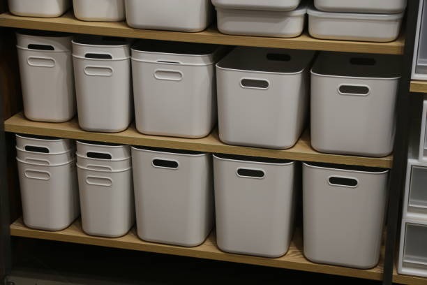 Plastic storage bins on wooden shelves for organized closet and pantry storage