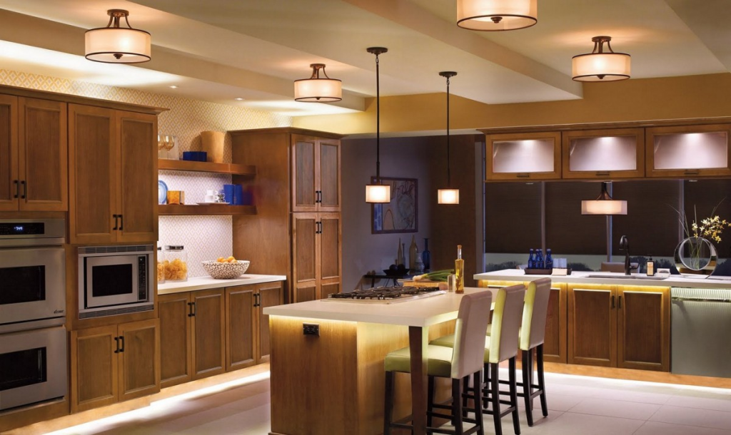 Modern kitchen design with warm wood cabinets, island seating, pendant lighting and built-in appliances
