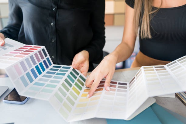 Interior designers choosing color palette samples for home decor and wall paint selection