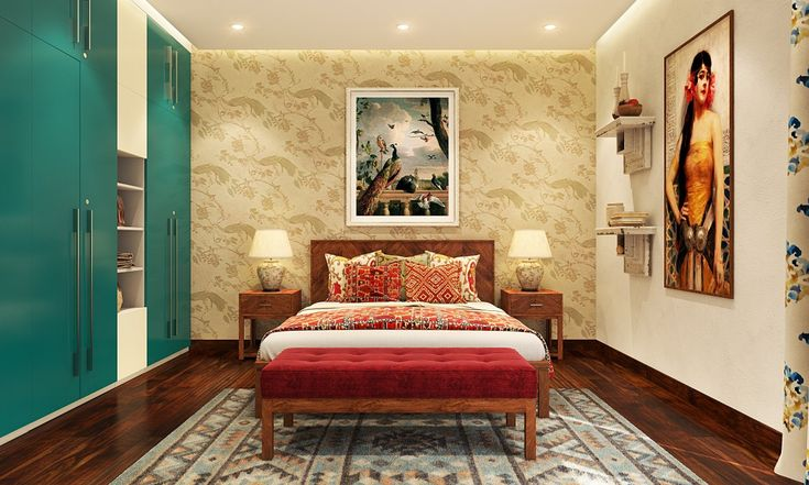 A bedroom with paintings on adjacent walls each having a different color scheme.