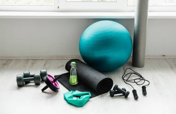 compact home workout equipment setup with yoga mat dumbbells resistance bands and exercise ball