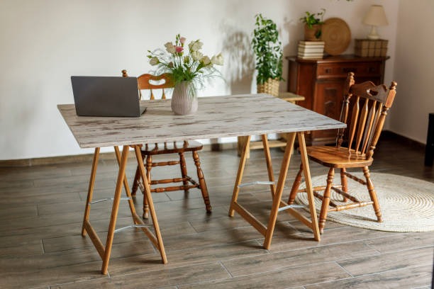 DIY farmhouse table project with wood tabletop on sawhorse legs indoors