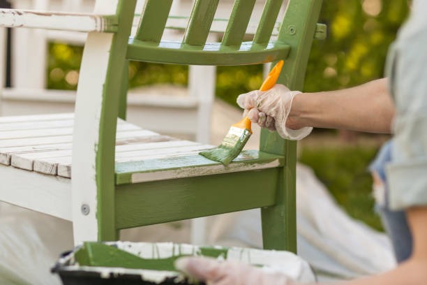 painting wooden chair with green paint for DIY furniture makeover project