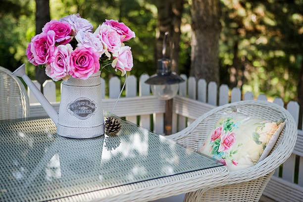 outdoor garden table decor with pink flowers wicker furniture and cozy patio setup
