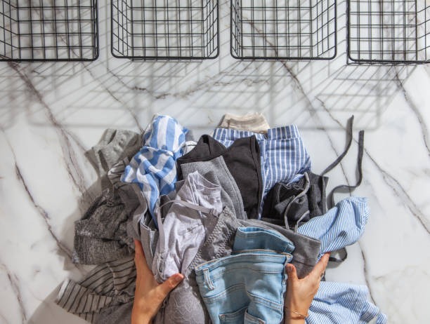 sorting clothes for decluttering with storage baskets and wardrobe organization ideas