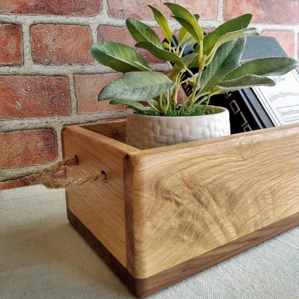 rustic wooden tray with potted green plant on table against brick wall for farmhouse home decor