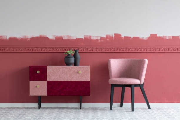 modern pink accent wall with painted cabinet and blush chair in stylish living room
