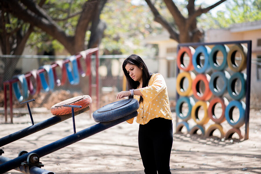 Repurposed tires used at a playground as seats on a see saw and other items.