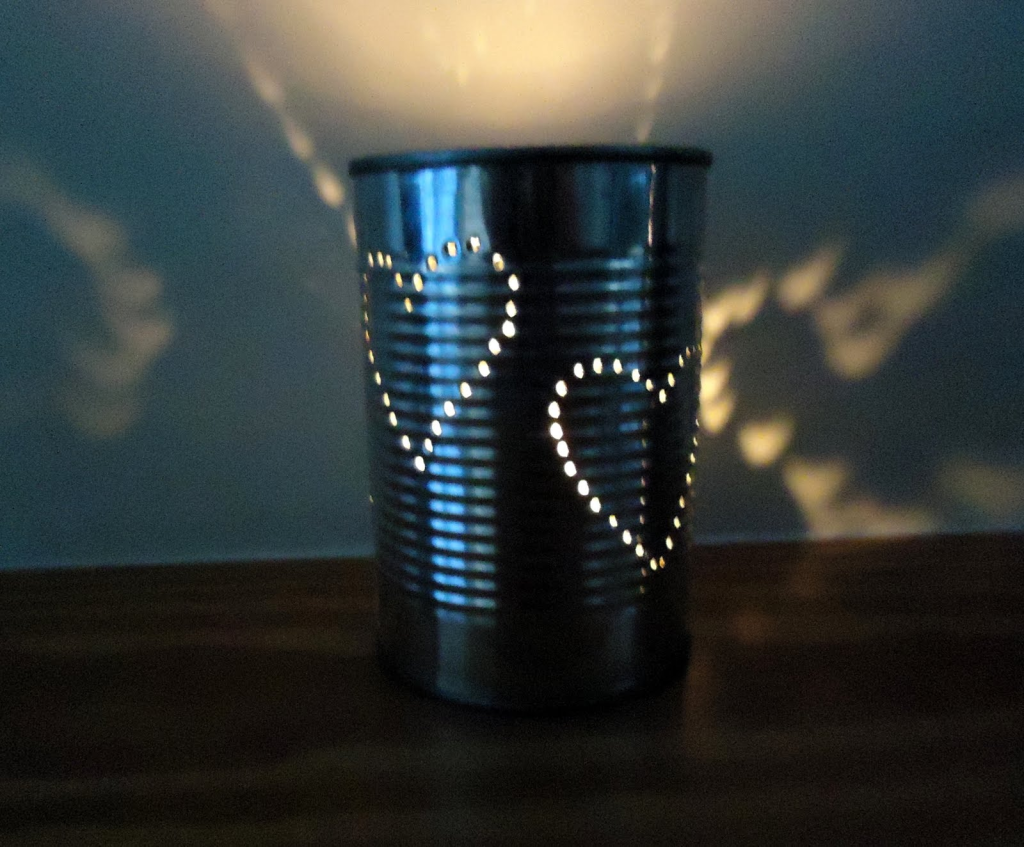 Dimly lit room with a can light designed in heart shapes on a tabletop.