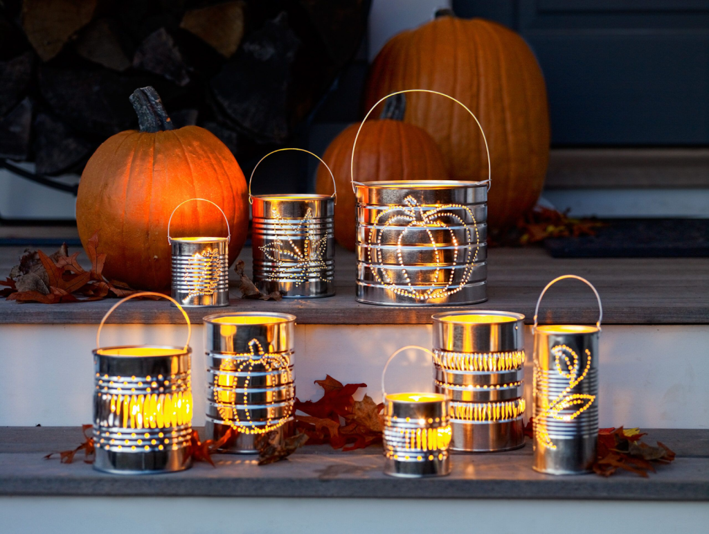 Different sized cans all with holes designed differently all lit on the front steps of a home.