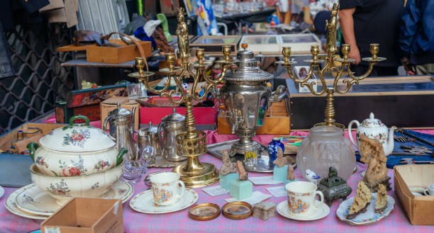 A table at a thrift shop filled with goods.