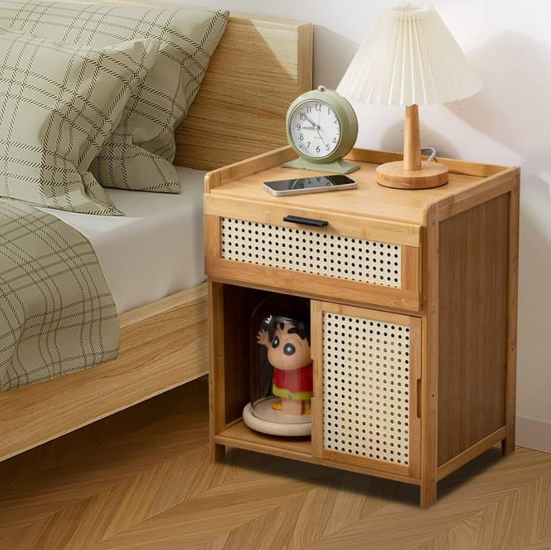 a nightstand with a lamp and a toy on it