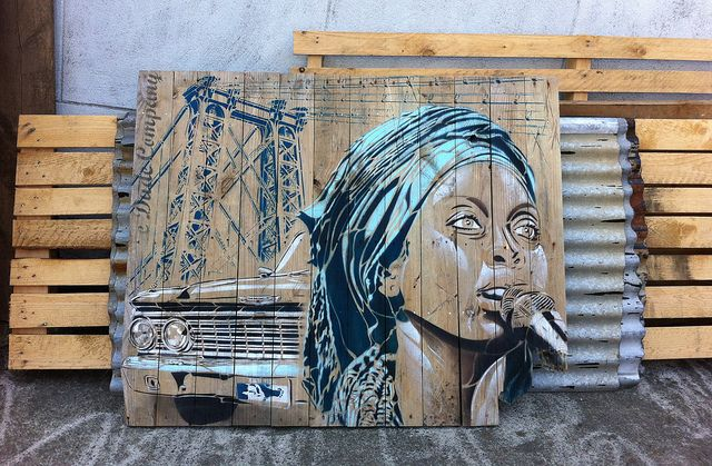 Portrait artwork painted on a pallet wood canvas with urban background