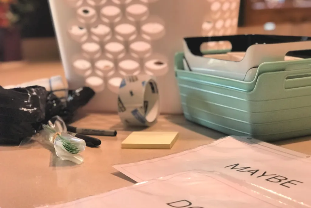 Closeup of bins, sticky notes and signs laying on the floor.