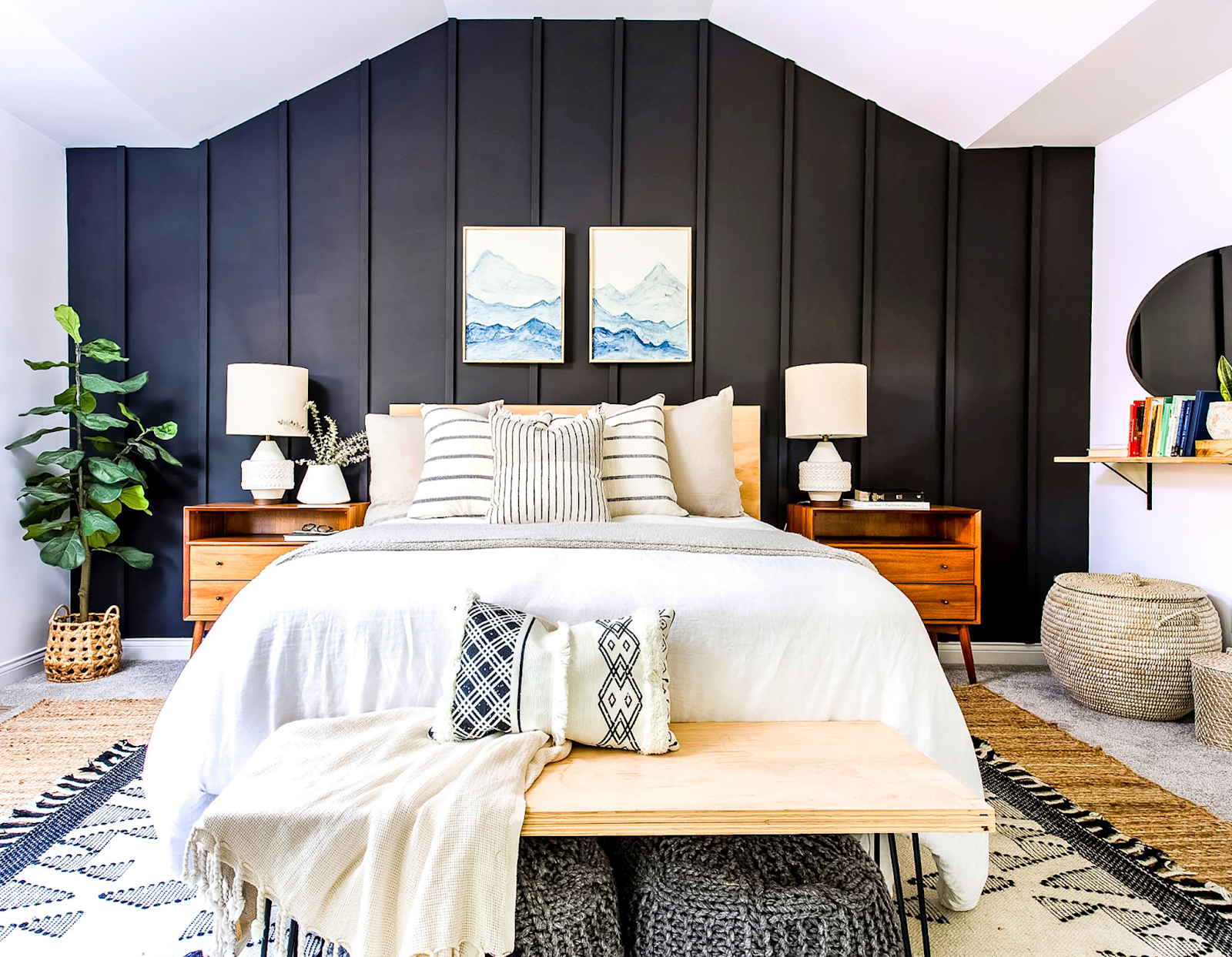A black planked accent wall in a bedroom with all other walls and ceiling being white.