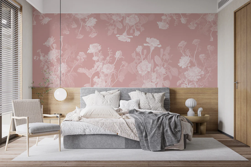 Pink floral wallpaper accent wall with wood chair rail in a bedroom.