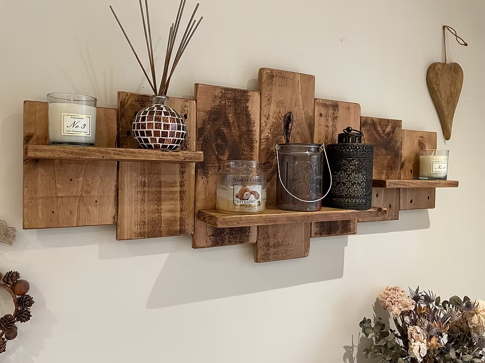 Wall-mounted pallet wood shelf decorated with candles and jars.