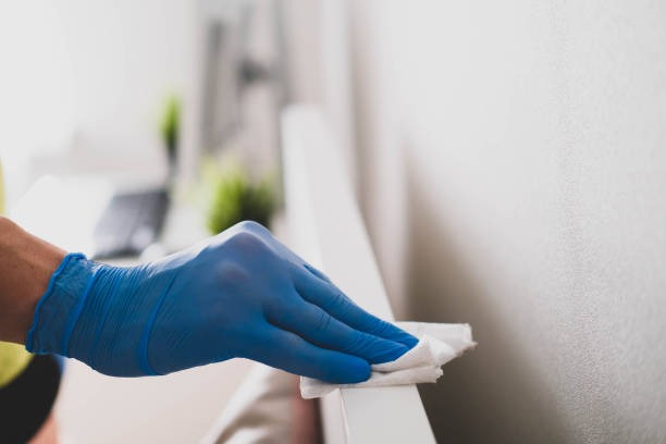Person cleaning surface with cloth