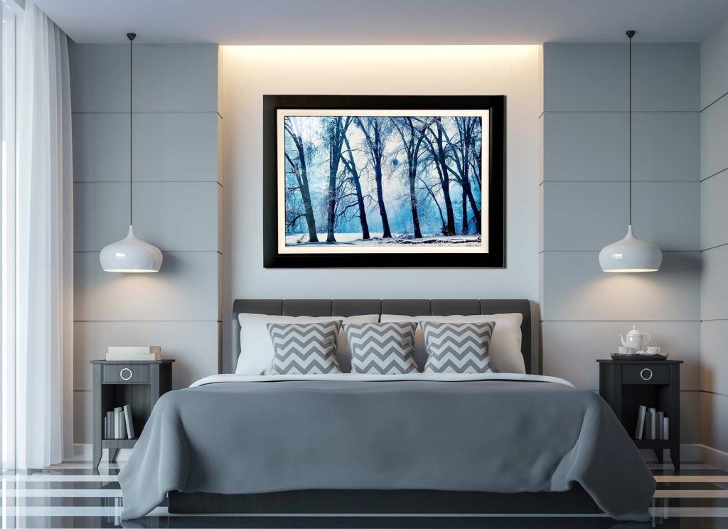 large painting of a snowing forest above the bed complementing the white textured themes of the bedroom.