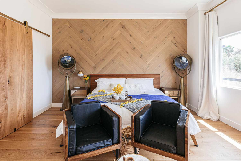 Modern bedroom with herringbone wood accent wall and minimalist décor