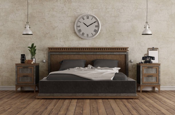 Industrial rustic bedroom with wooden bed frame, distressed wall, large wall clock, and pendant lighting