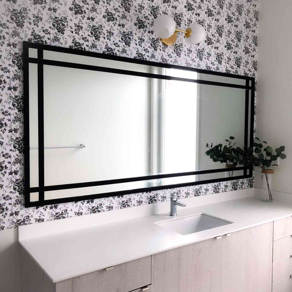 A black frame around a large rectangular mirror.