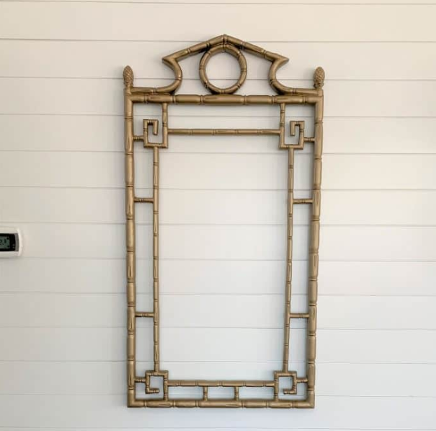 Faux bamboo frame on a white paneled wall.